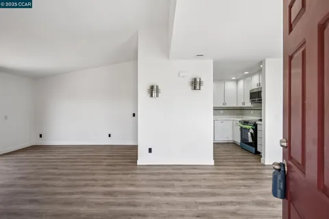 a view of a kitchen with wooden floor
