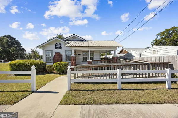 a view of a house with a yard and deck
