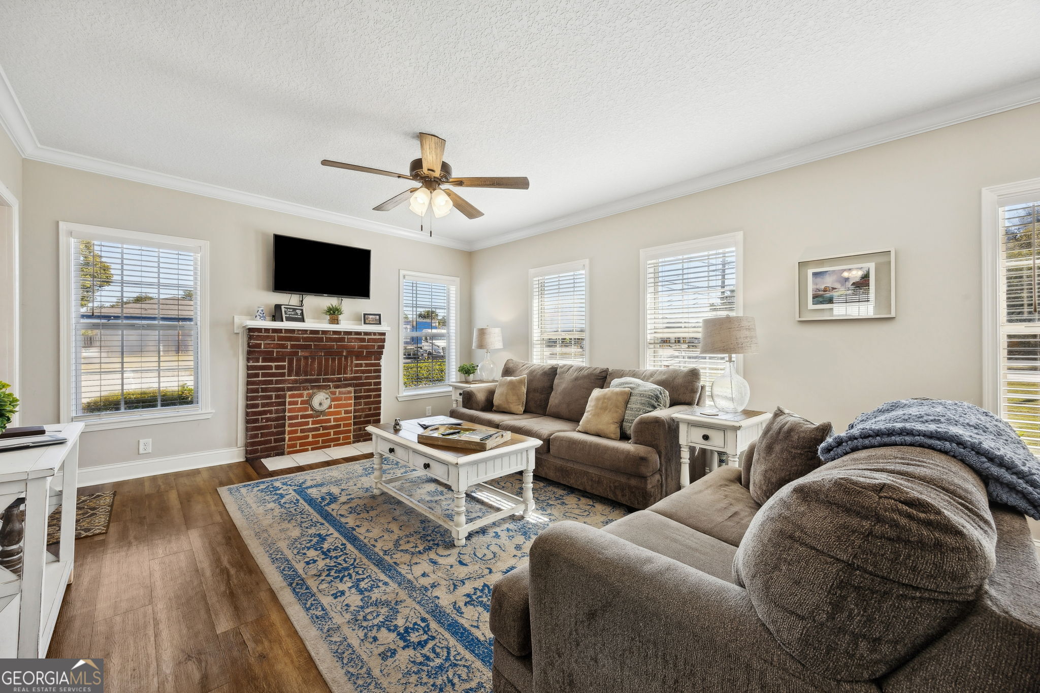 383 1st Street Folkston, GA 31537 - Photo 14 of 81 a living room with furniture a flat screen tv and a fireplace