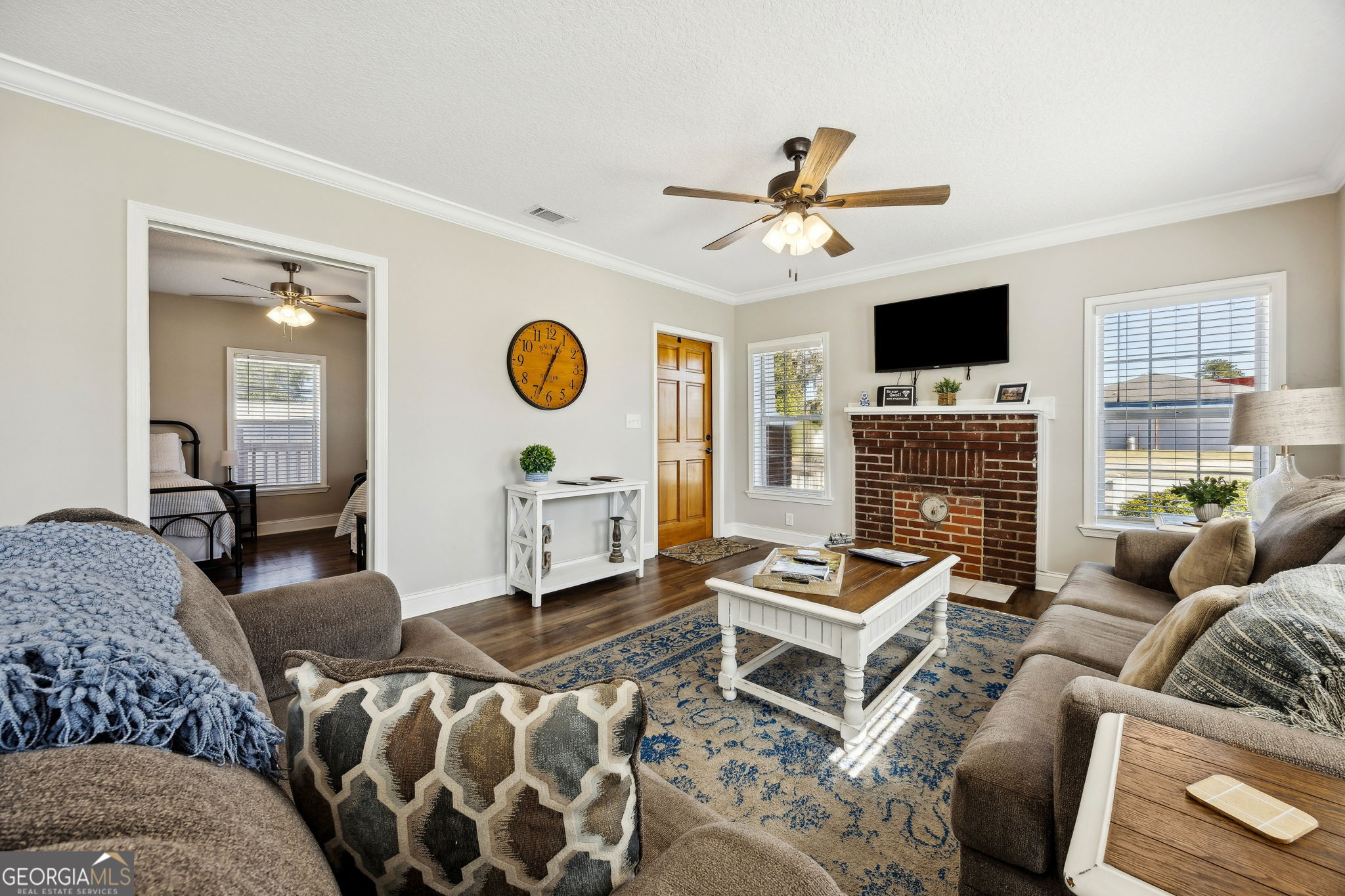 383 1st Street Folkston, GA 31537 - Photo 15 of 81 a living room with furniture a flat screen tv and a fireplace