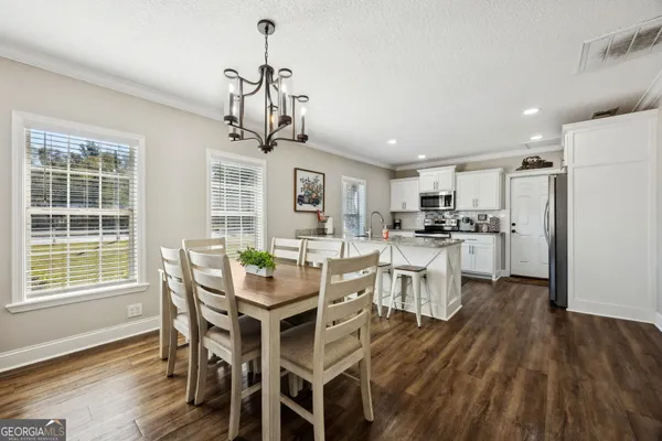 a kitchen with stainless steel appliances granite countertop a sink and cabinets
