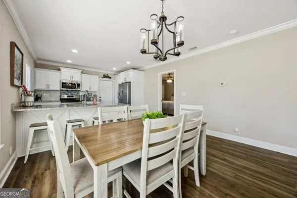 a kitchen with white cabinets and appliances