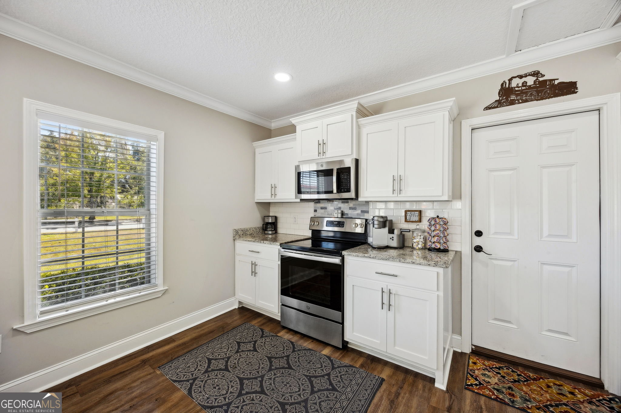 383 1st Street Folkston, GA 31537 - Photo 24 of 81 a kitchen with white cabinets and appliances