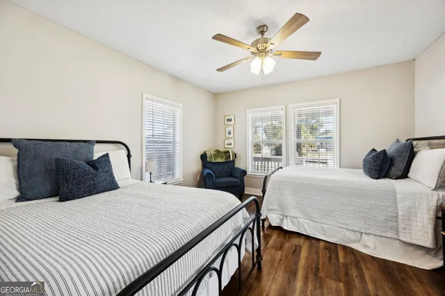 a view of a backyard with a chair and wooden fence