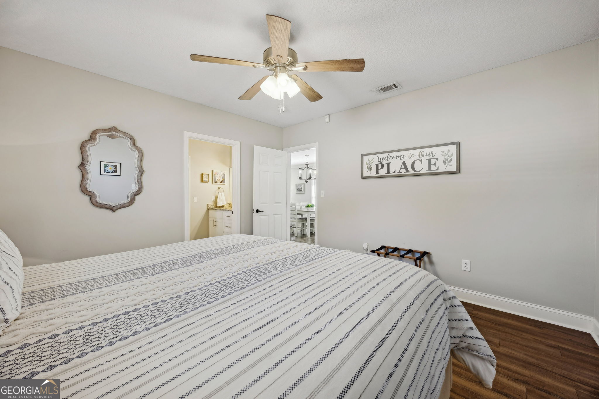 383 1st Street Folkston, GA 31537 - Photo 37 of 81 a bedroom with a bed and a chandelier