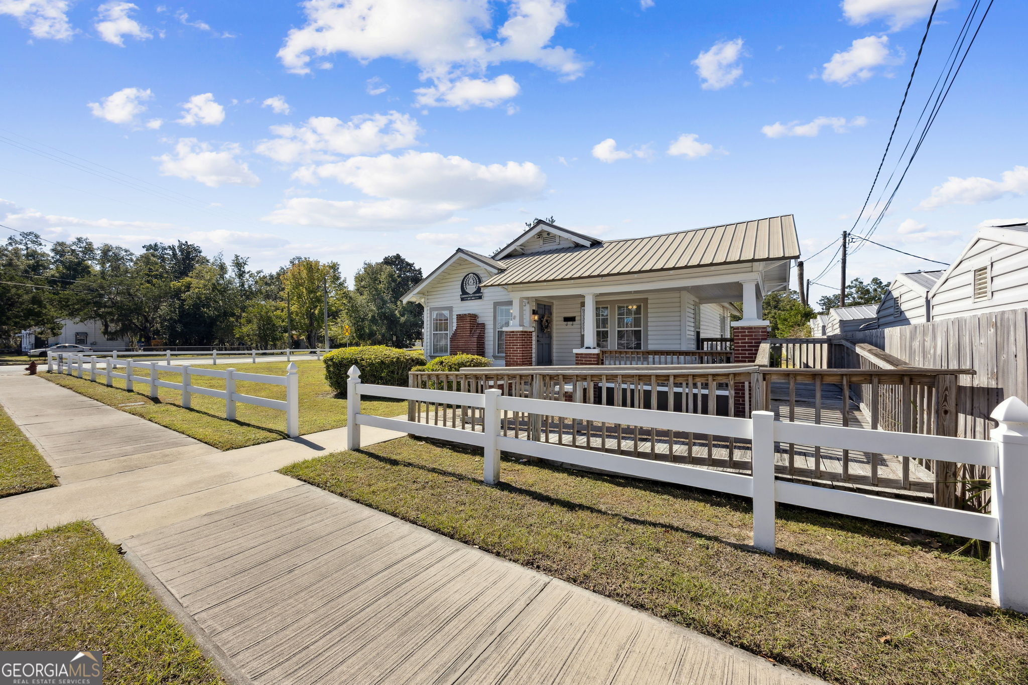 383 1st Street Folkston, GA 31537 - Photo 4 of 81 a view of a house with wooden deck and sitting area