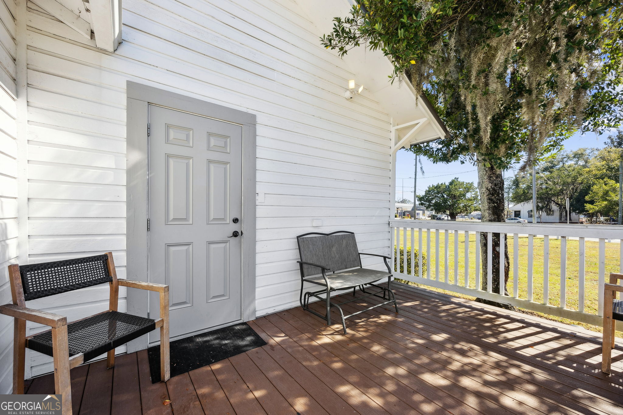 383 1st Street Folkston, GA 31537 - Photo 41 of 81 a view of a backyard with a chair and wooden fence