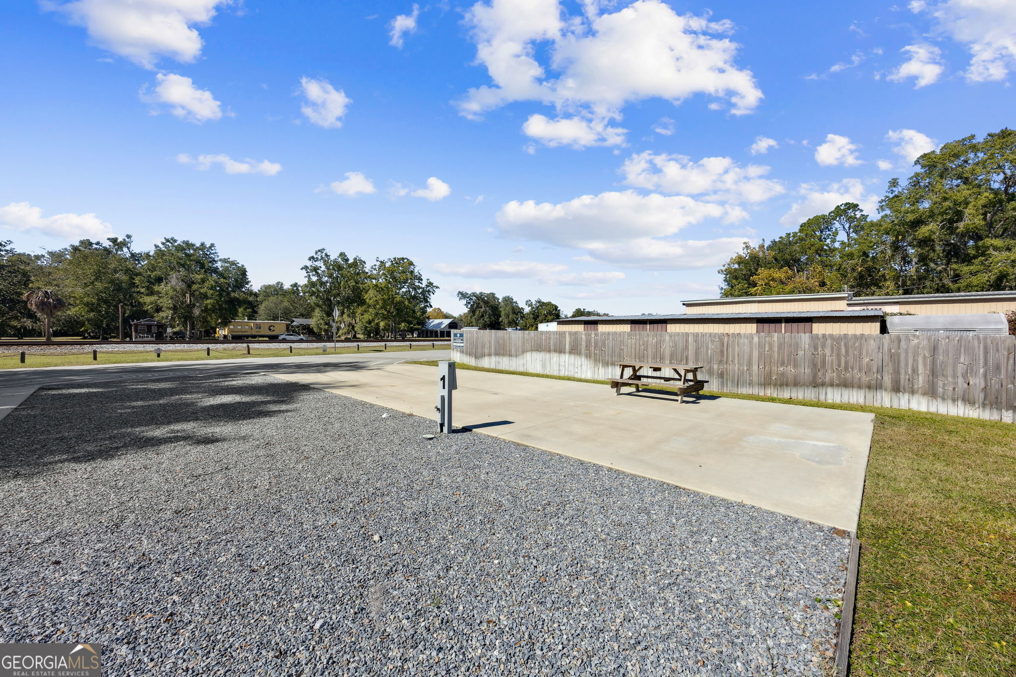 383 1st Street Folkston, GA 31537 - Photo 59 of 81 a swimming pool with lots of trees in the background
