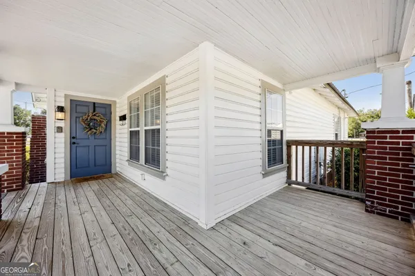 a view of a balcony with wooden floor