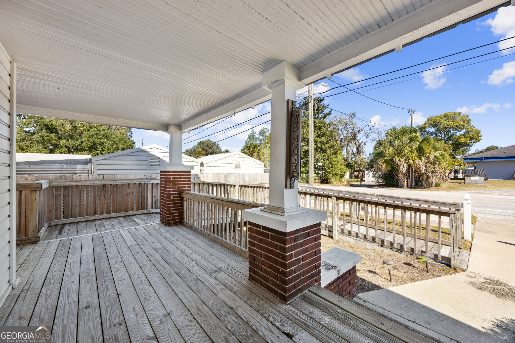 383 1st Street Folkston, GA 31537 - Photo 9 of 81 a view of a chairs on wooden deck