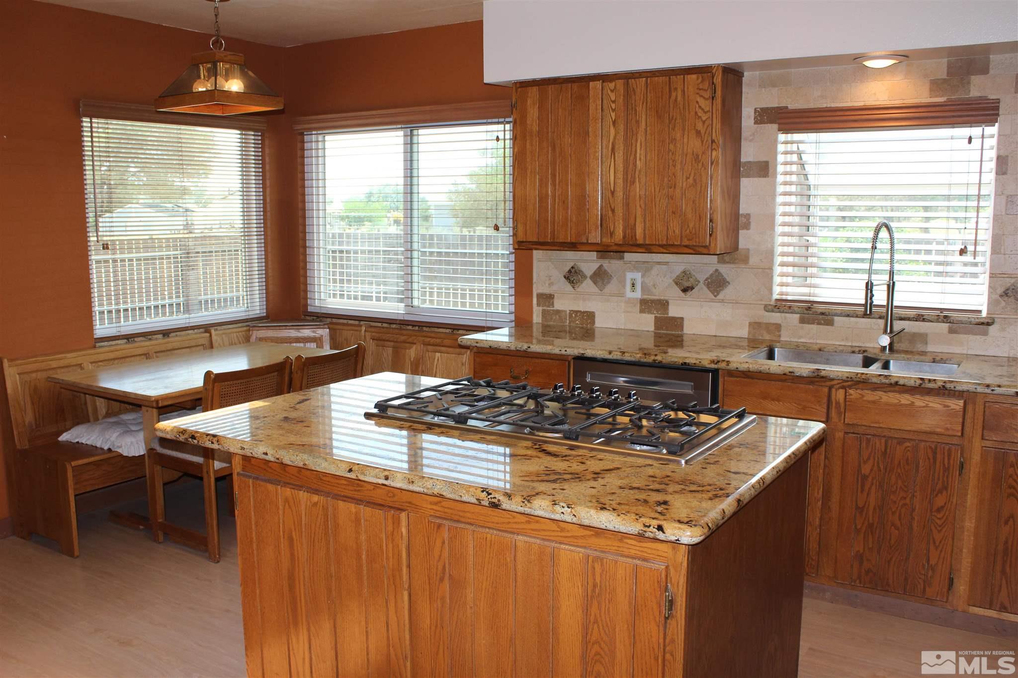 3425 Sorensen Road Fallon, NV 89406 - Photo 12 of 37 a kitchen with granite countertop a sink stove and cabinets