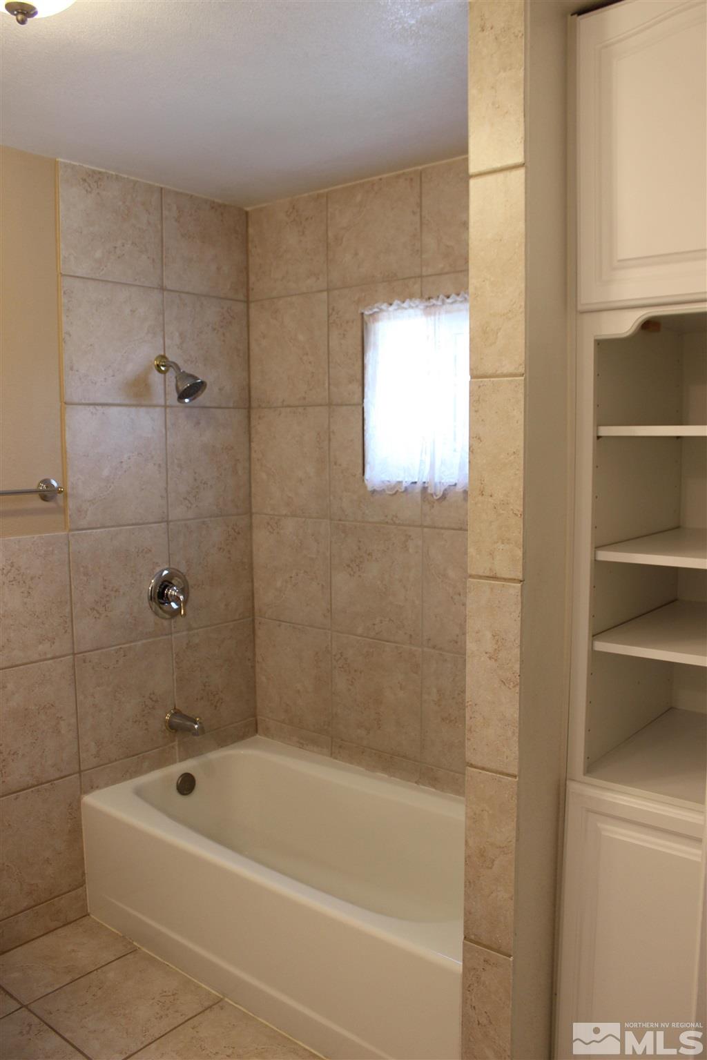 3425 Sorensen Road Fallon, NV 89406 - Photo 22 of 37 a bathroom with a bathtub and a shower