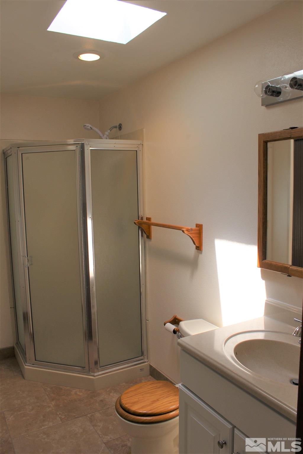 3425 Sorensen Road Fallon, NV 89406 - Photo 23 of 37 a bathroom with a granite countertop sink toilet and shower