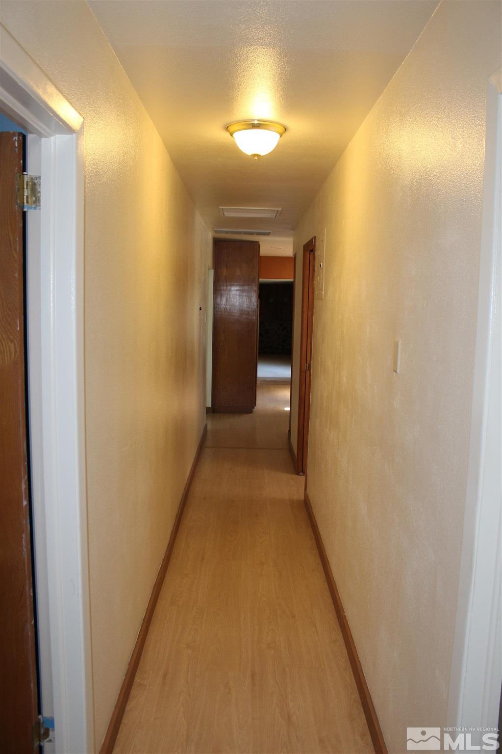 3425 Sorensen Road Fallon, NV 89406 - Photo 27 of 37 a view of a hallway with wooden floor