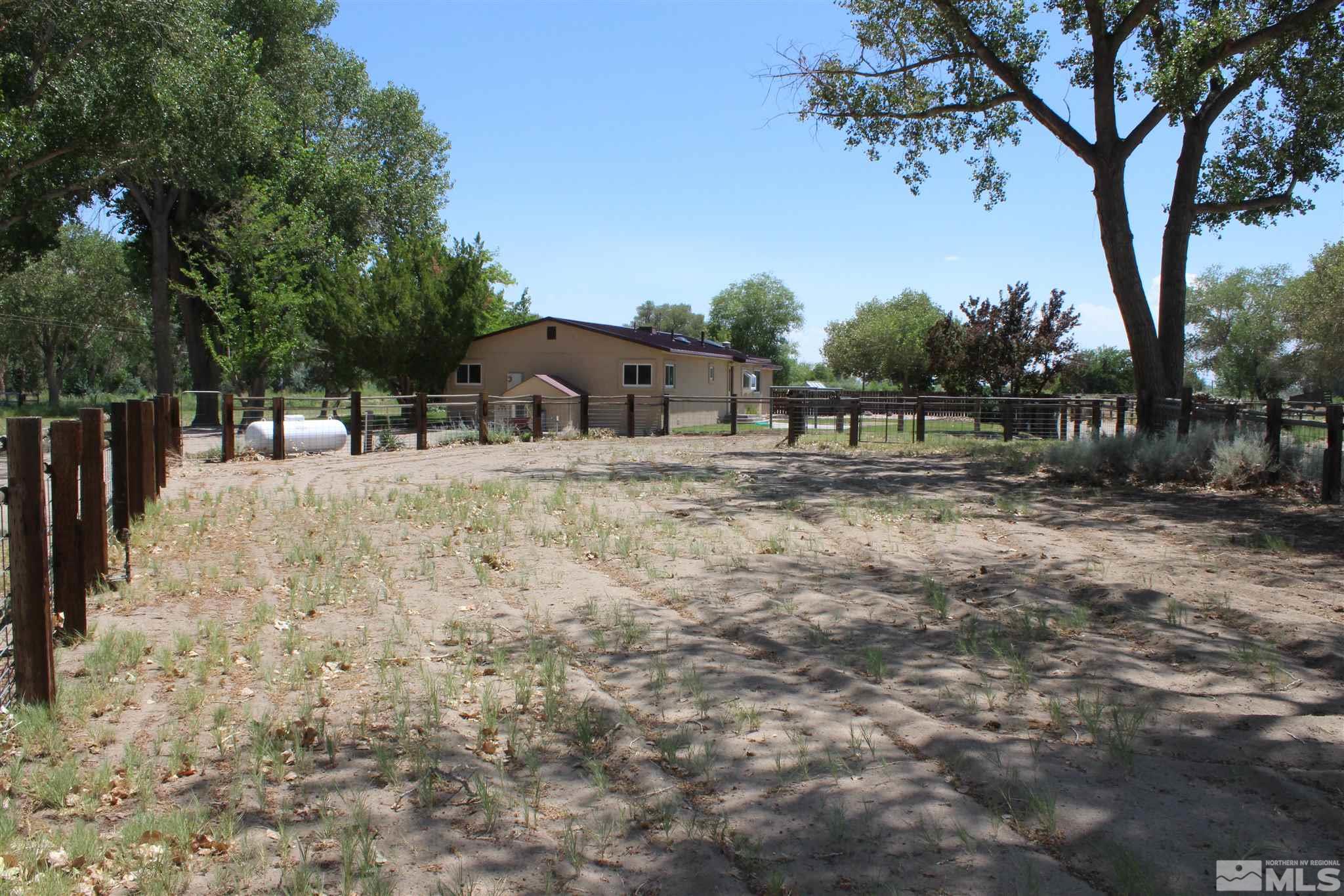 3425 Sorensen Road Fallon, NV 89406 - Photo 4 of 37 a view of backyard with large trees and wooden fence