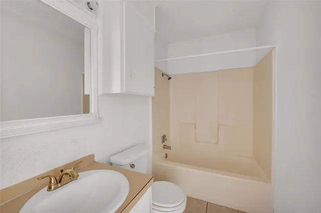 a white toilet sitting next to a bath tub
