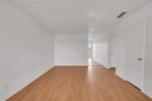 a view of an empty room and wooden floor