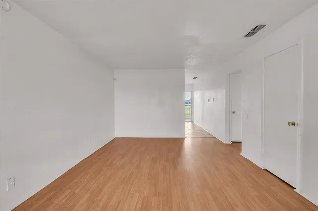 a view of an empty room and wooden floor