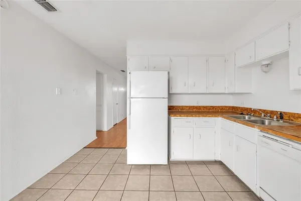 a white refrigerator freezer sitting inside of a kitchen