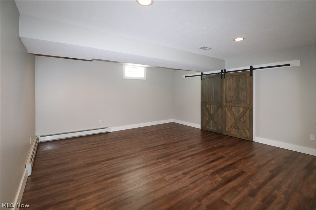1153 East Pleasant Home Road Wooster, OH 44691 - Photo 29 of 48 Living room/rec room with barn doors to storage area