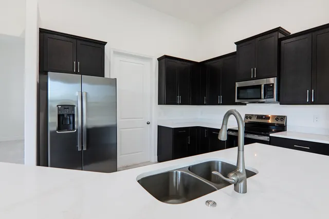 a kitchen with a sink and a refrigerator