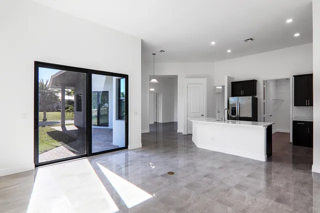 an empty room with an entryway and hallway