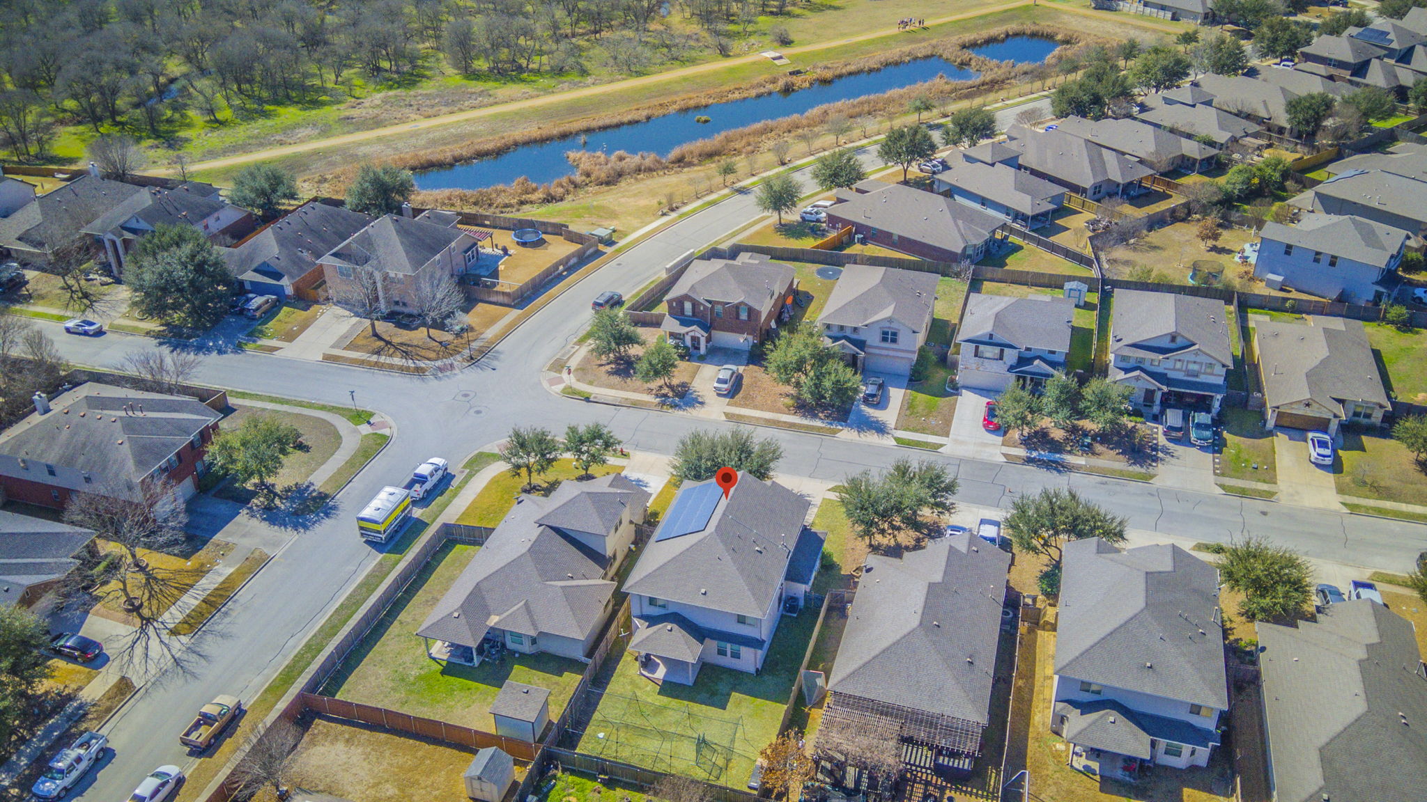 1366 Heep Run Buda, TX 78610 - Photo 33 of 37 Aerial view of property and surrounding area featuring nearby suburban area and a large body of water