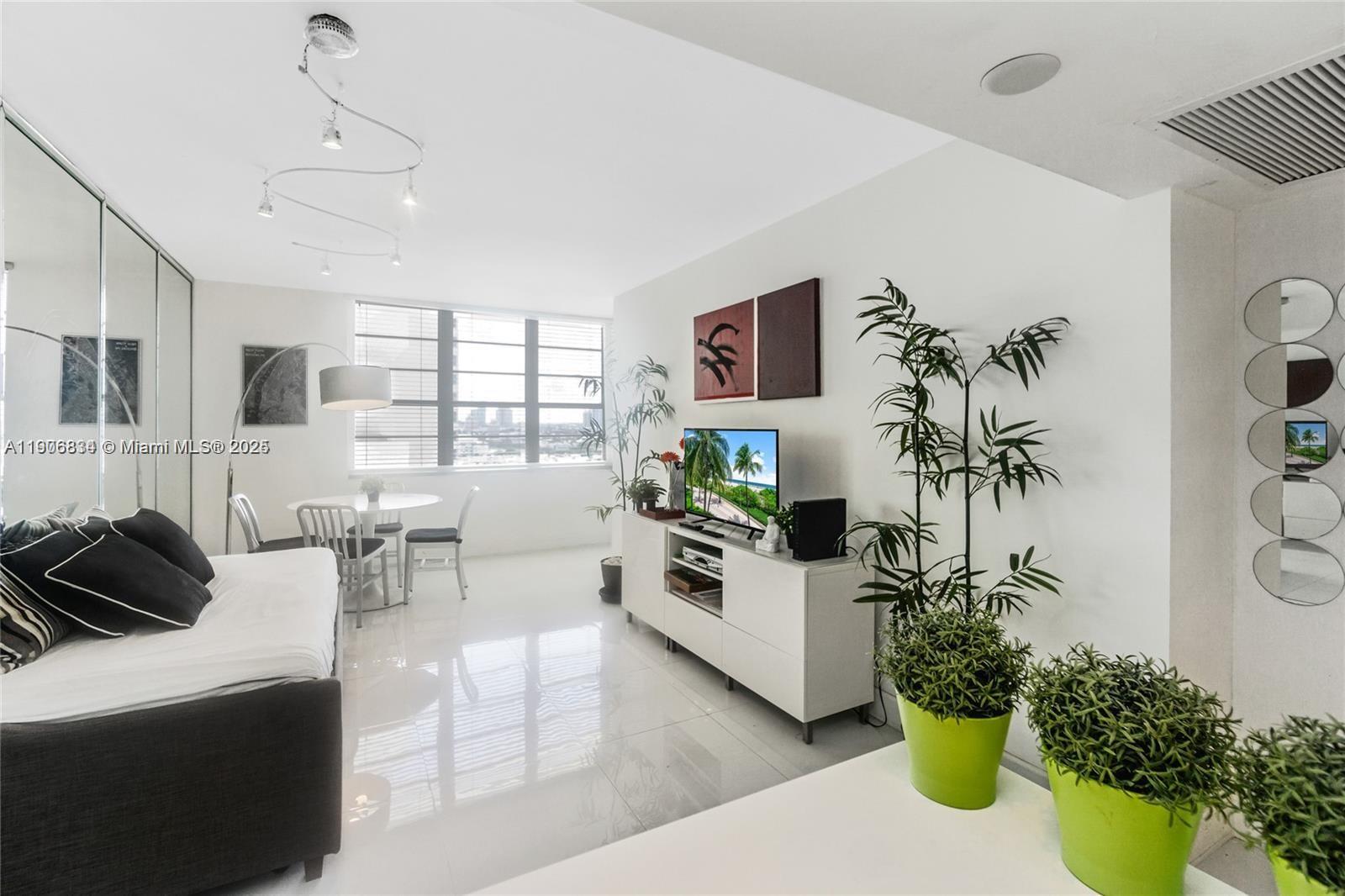 100 Lincoln Road, Unit 1201 Miami Beach, FL 33139 - Photo 2 of 19 a living room with furniture and a potted plant