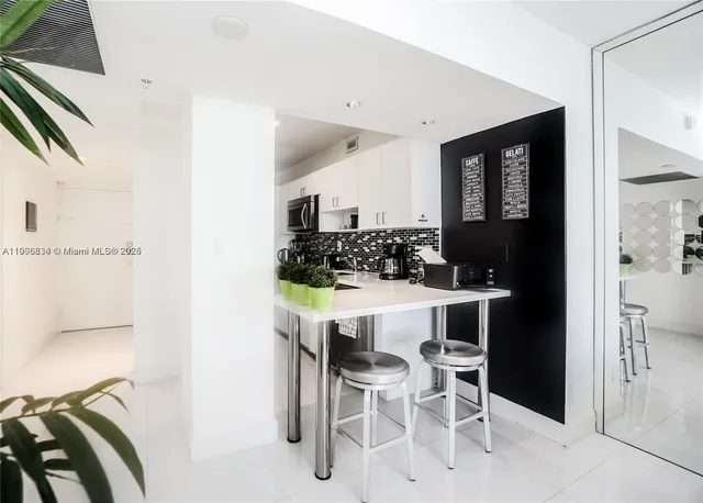 a kitchen with a table and chairs