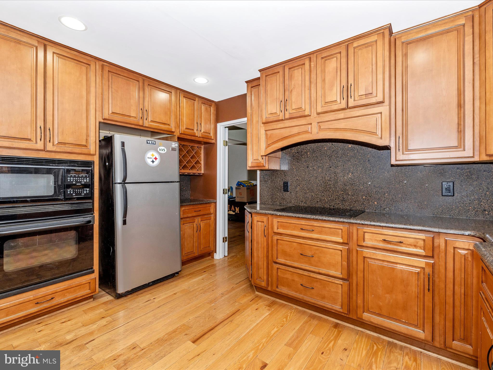 5880 Union Ridge Drive Adamstown, MD 21710 - Photo 16 of 49 a kitchen with granite countertop a refrigerator and cabinets