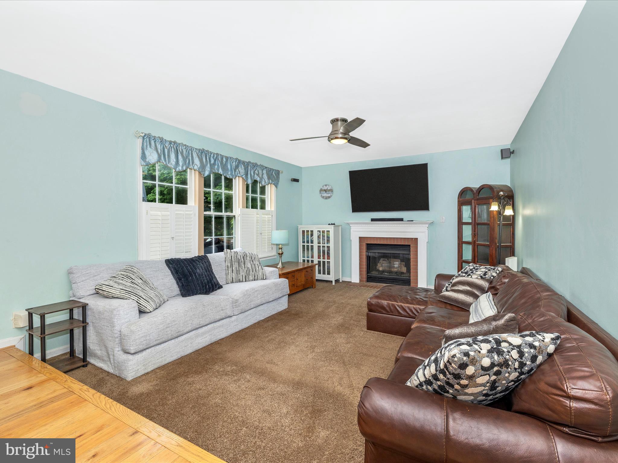 5880 Union Ridge Drive Adamstown, MD 21710 - Photo 20 of 49 a living room with furniture a fireplace and a flat screen tv
