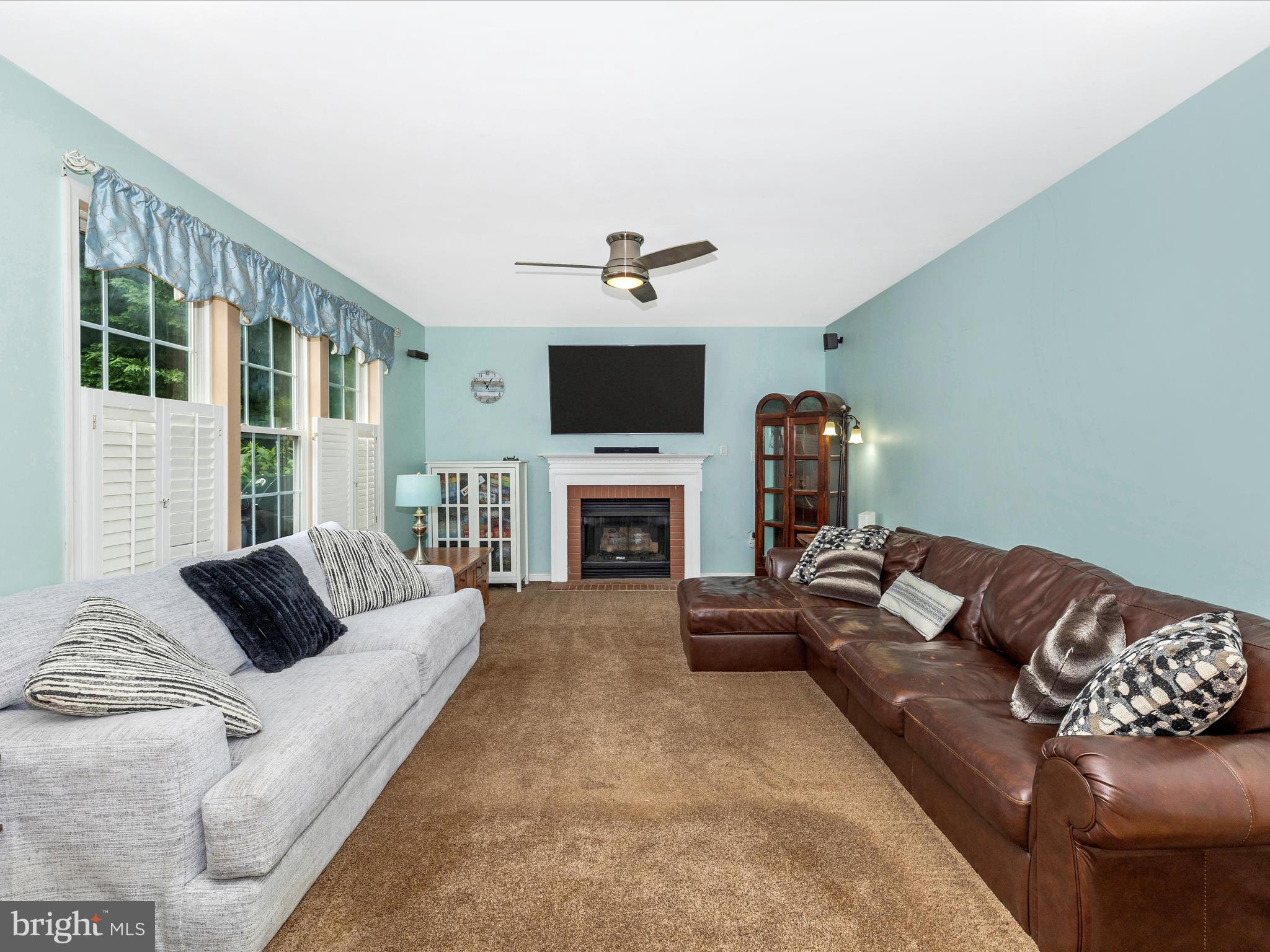 5880 Union Ridge Drive Adamstown, MD 21710 - Photo 21 of 49 a living room with furniture a fireplace and a flat screen tv