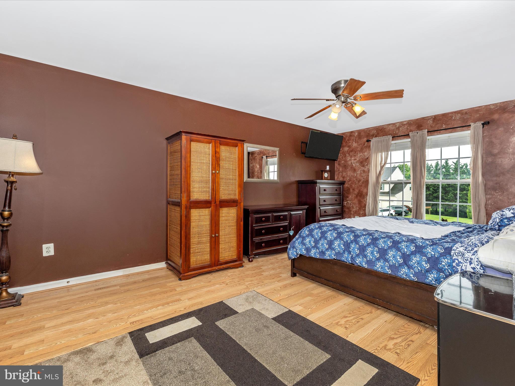 5880 Union Ridge Drive Adamstown, MD 21710 - Photo 26 of 49 a bedroom with a large bed a flat tv screen and dresser
