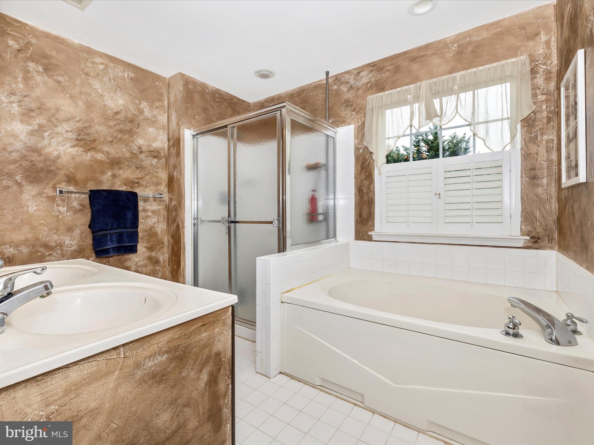 5880 Union Ridge Drive Adamstown, MD 21710 - Photo 29 of 49 a bathroom with a tub a sink and a window