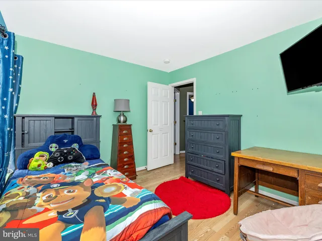 a bedroom with a bed and a television