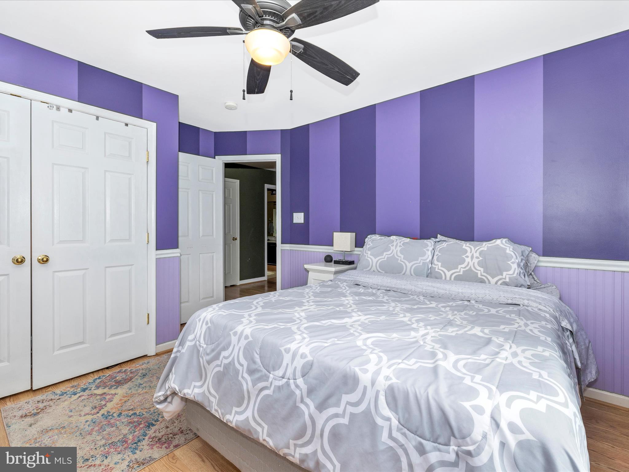 5880 Union Ridge Drive Adamstown, MD 21710 - Photo 36 of 49 a large bed with a large mirror on dresser and a chandelier