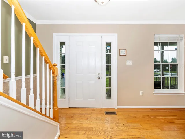 a view of an entryway with wooden floor
