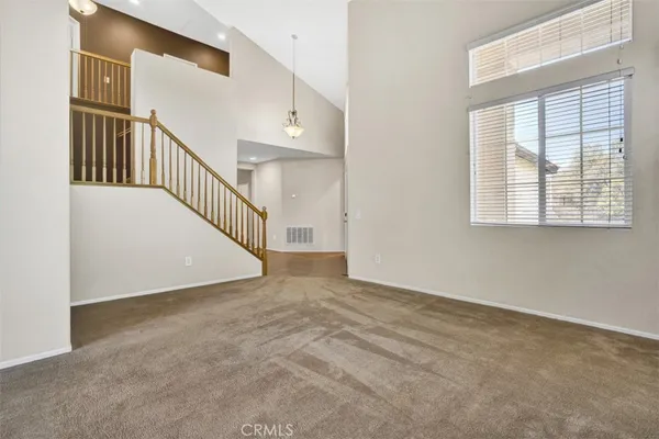 a view of an empty room with stairs