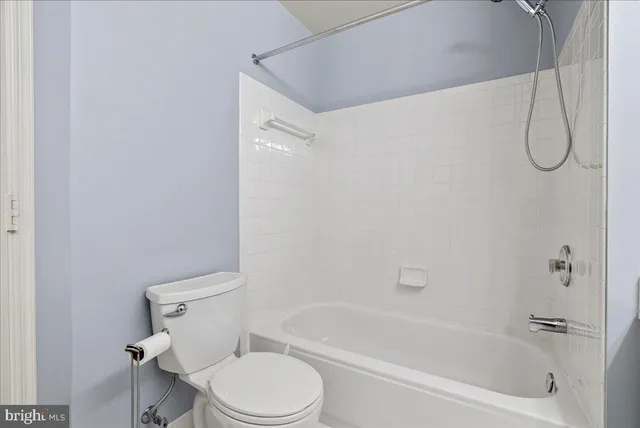 a bathroom with a toilet and a bath tub