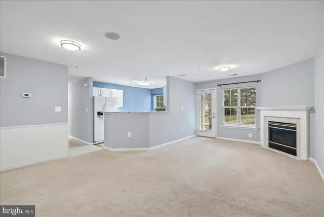 a view of a livingroom with a fireplace and window