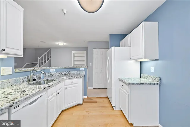 a kitchen with a sink stove and refrigerator