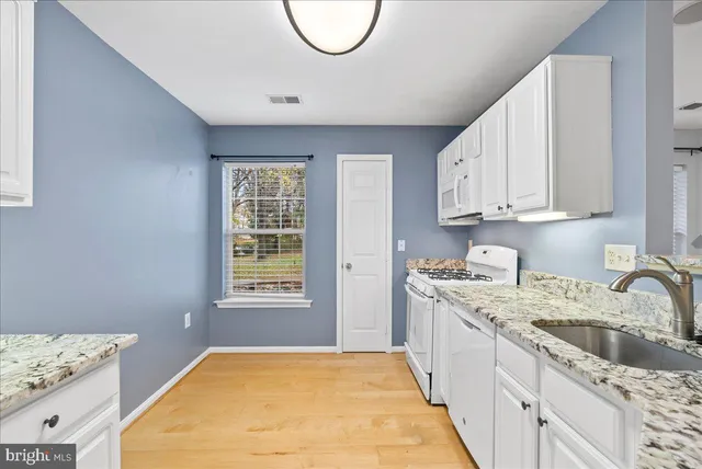 a kitchen with a sink stove and cabinets