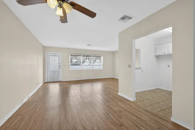 wooden floor in an empty room with a window