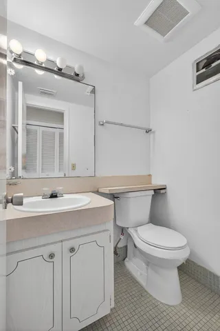 a bathroom with a sink toilet and mirror