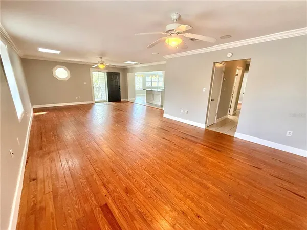 wooden floor in an empty room with a window