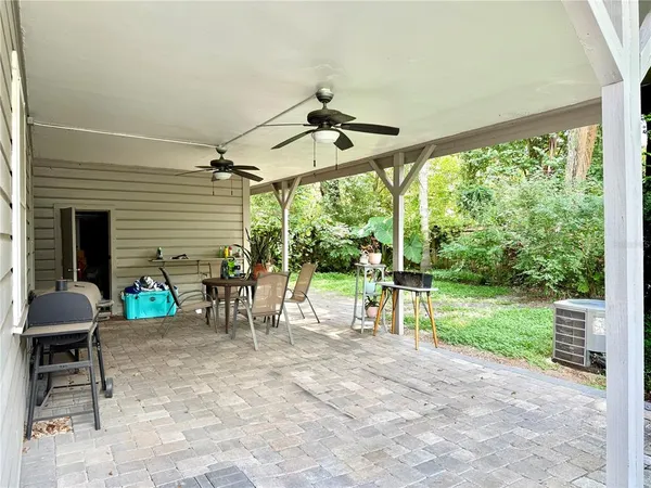 a view of a porch with chairs and backyard