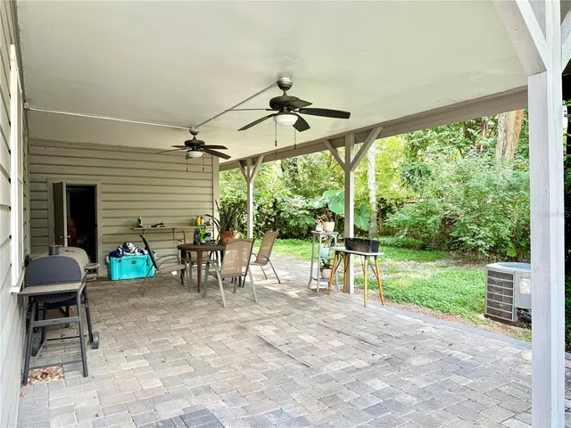 a view of a porch with chairs and backyard
