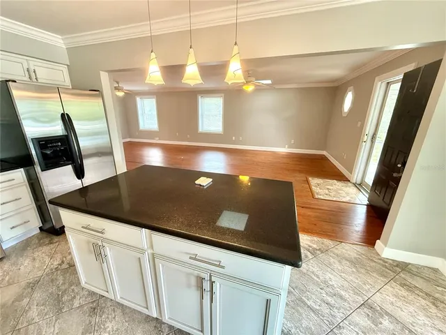 a view of a kitchen with a sink and dishwasher with wooden floor