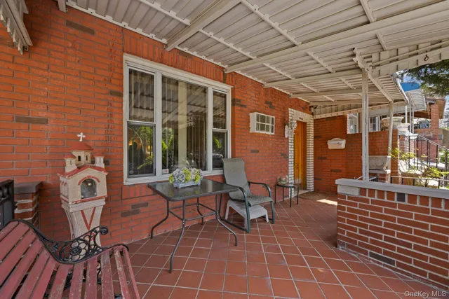 a view of a patio with table and chairs and potted plants