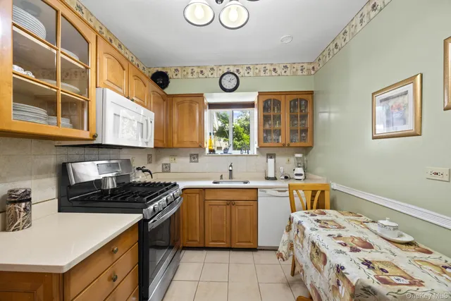 a kitchen with a sink stove top oven and cabinets